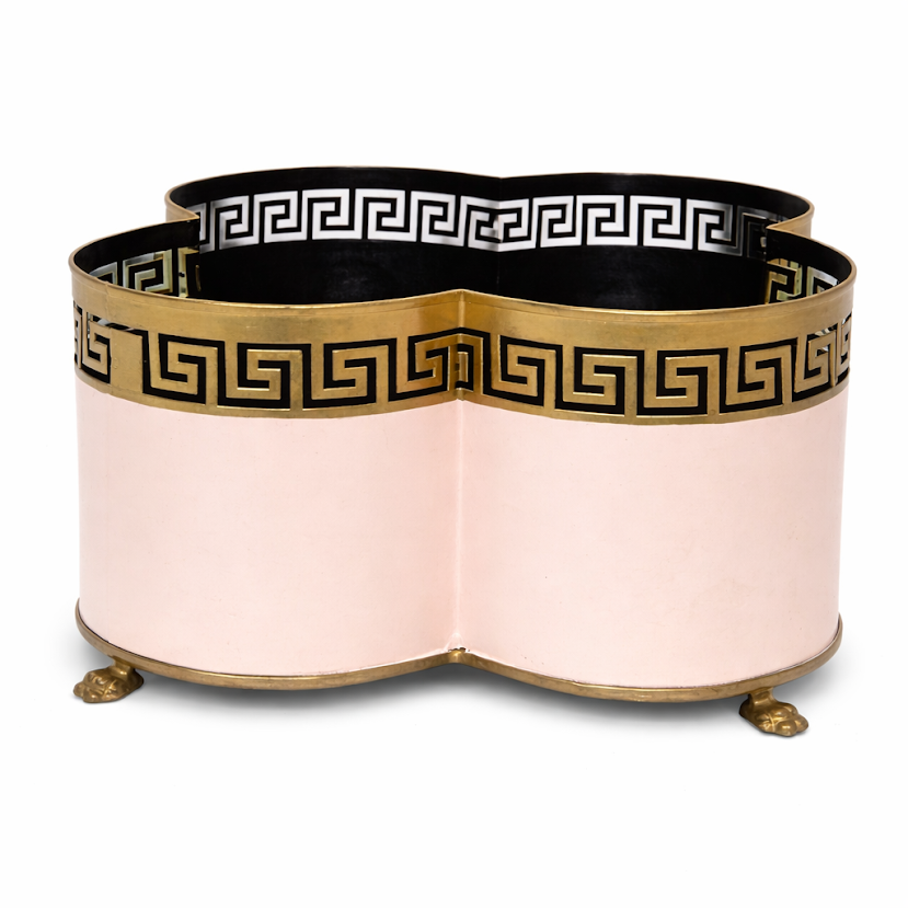 Decorative pink and gold planter with Greek key design on a white background