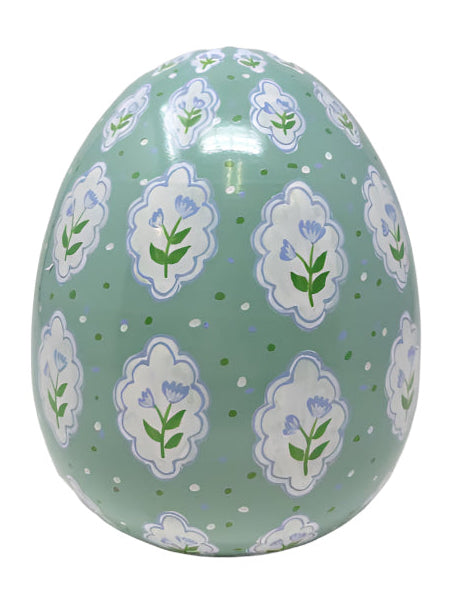 Decorative egg with floral pattern on a green background