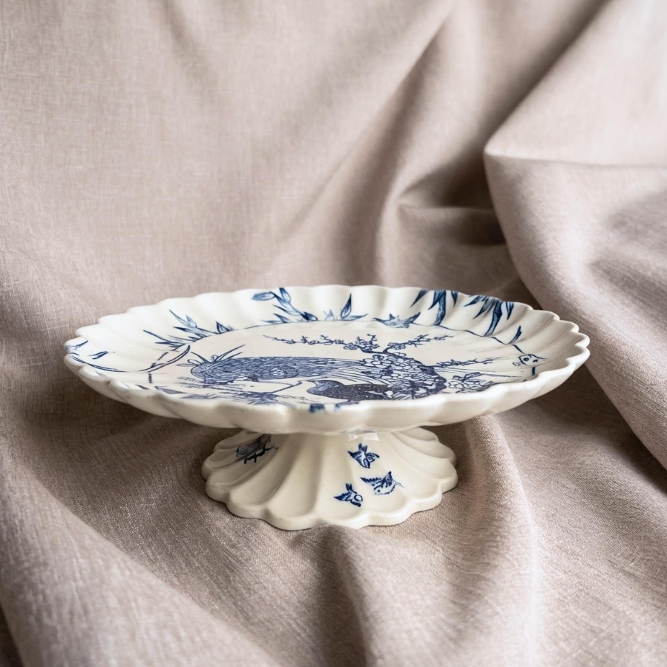 Rare 1880 Copeland pedestal comports in cobalt Japonisme design on a beige fabric background