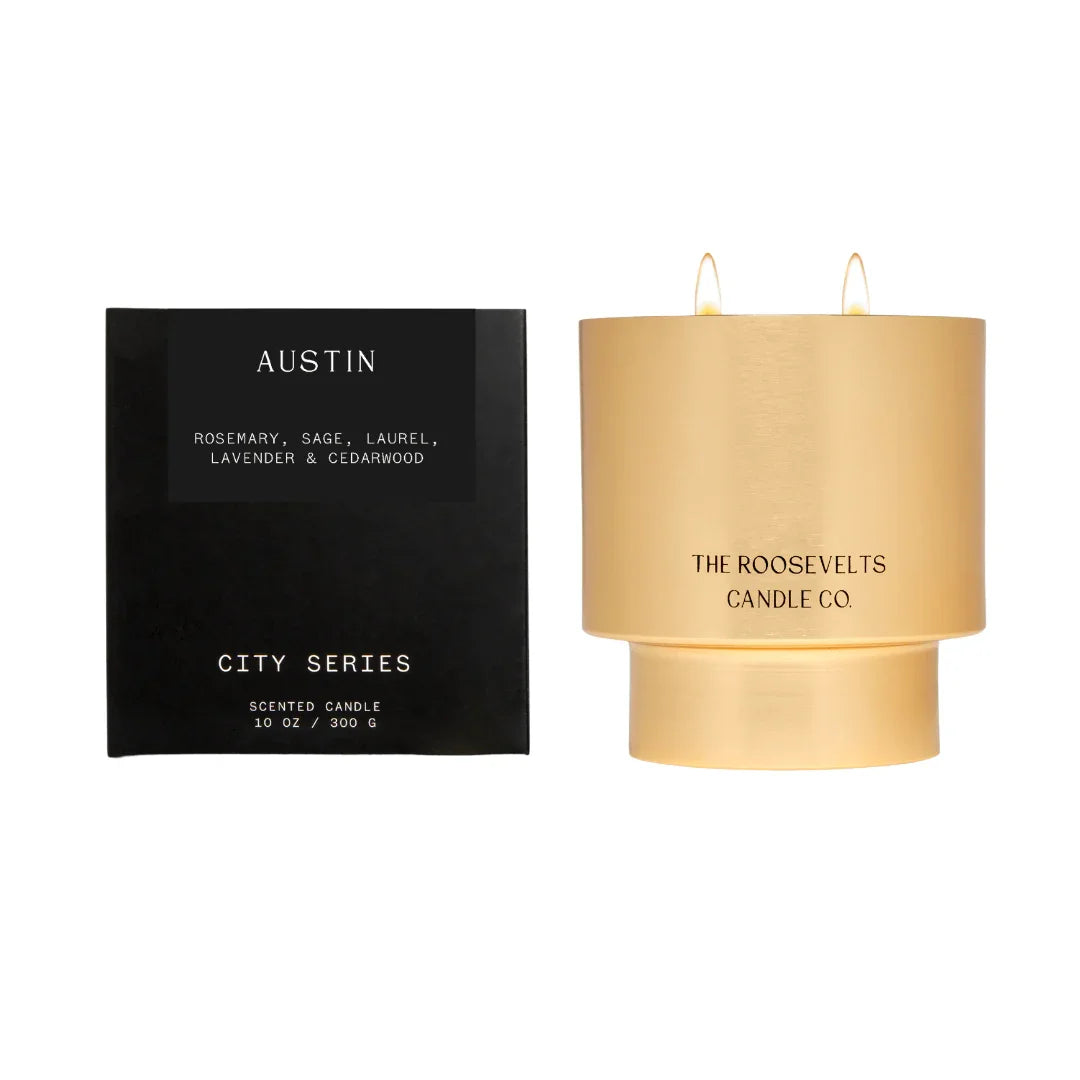 Gold candle and black packaging with 'Austin' and 'The Roosevelts Candle Co.' text on a white background