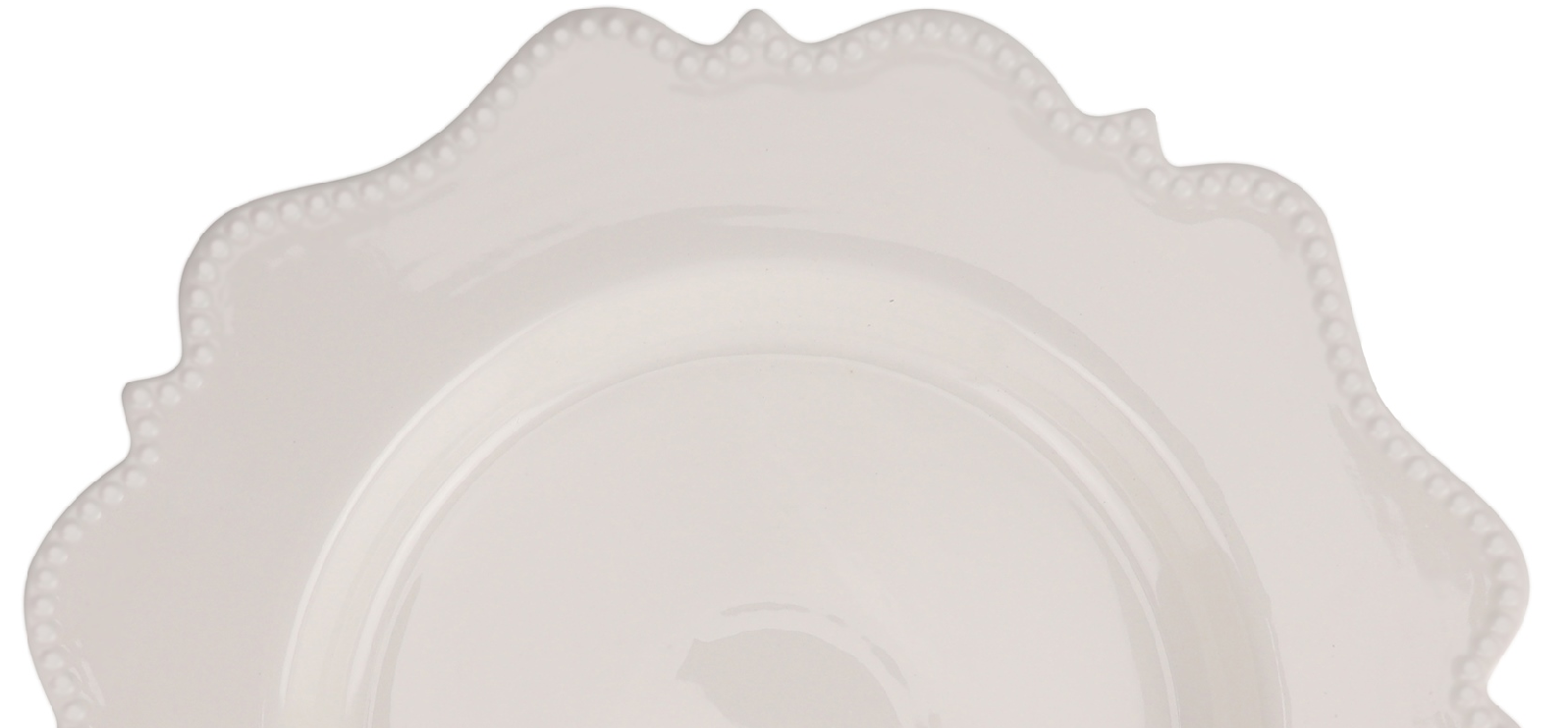 White decorative plate with scalloped edge on a white background