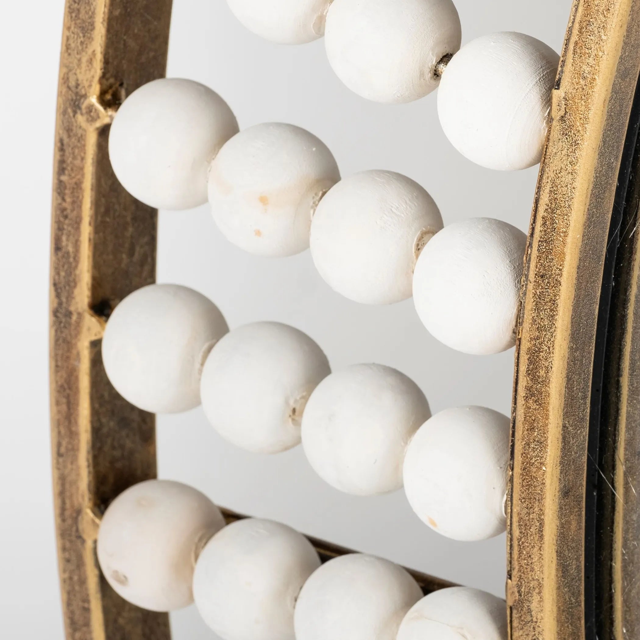 Wooden crate filled with white spherical objects on a light background