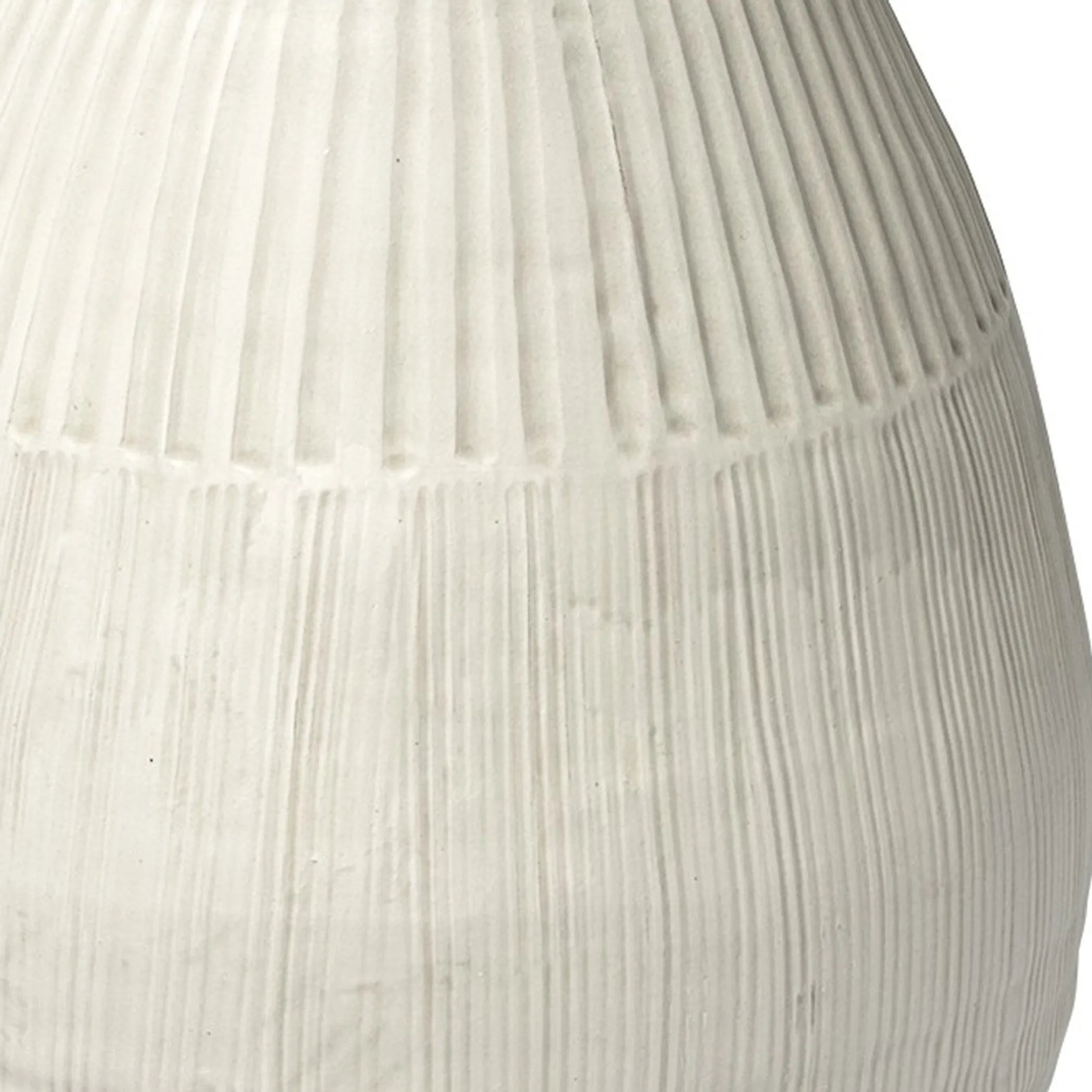 Close-up of a textured white vase on a white background