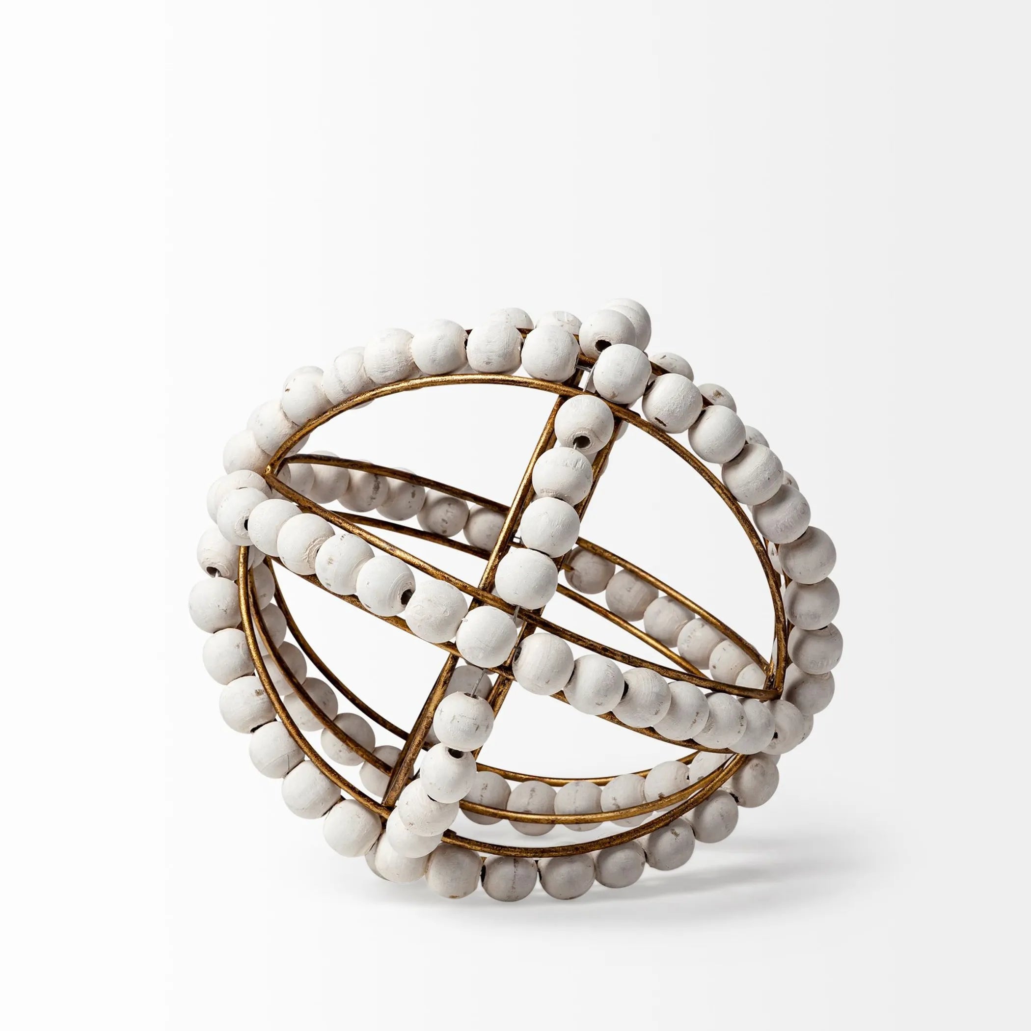 Decorative spherical object with white beads and gold accents on a light gray background