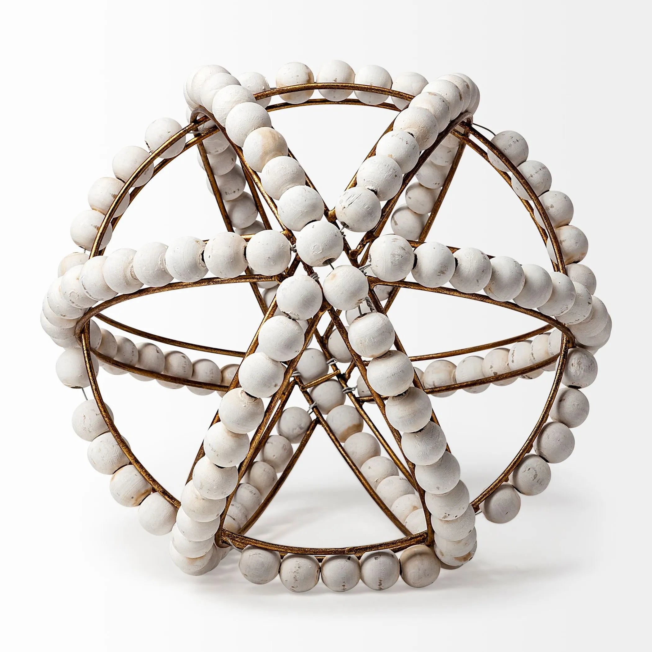 Decorative object with white beads and gold wire seen from above, on a white background