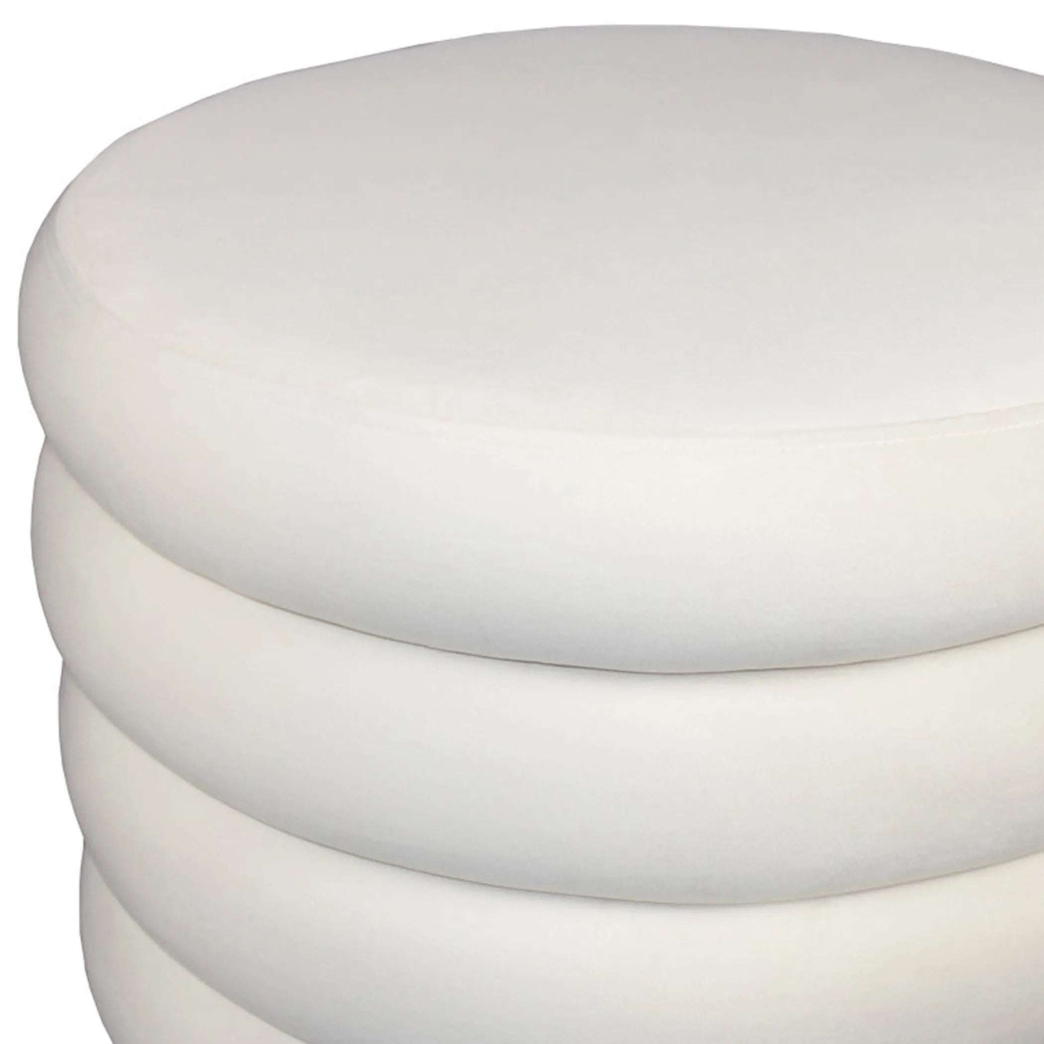 Close-up of a white cylindrical velvet ottoman on a white background