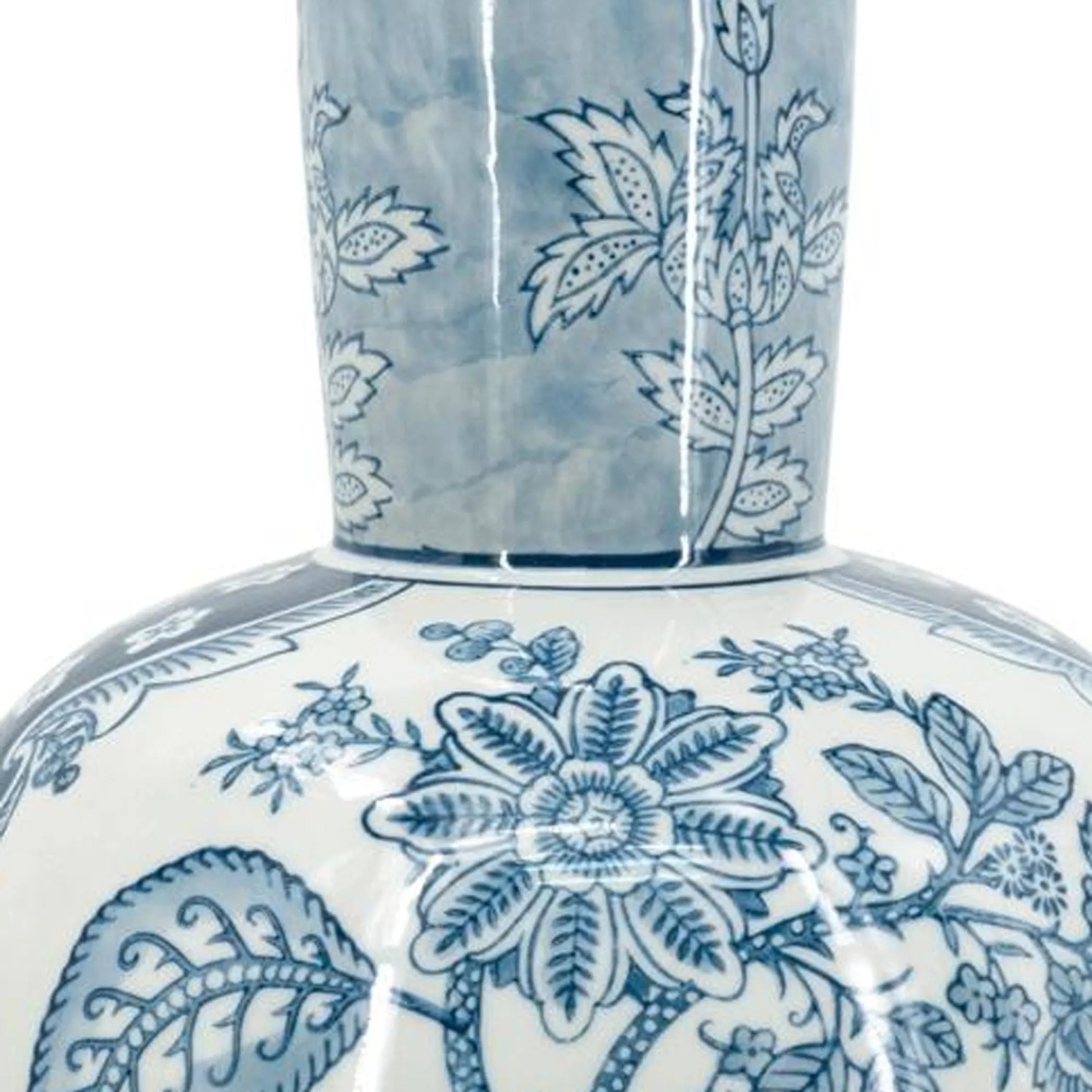 Close up of a ceramic vase with blue floral patterns on a white background