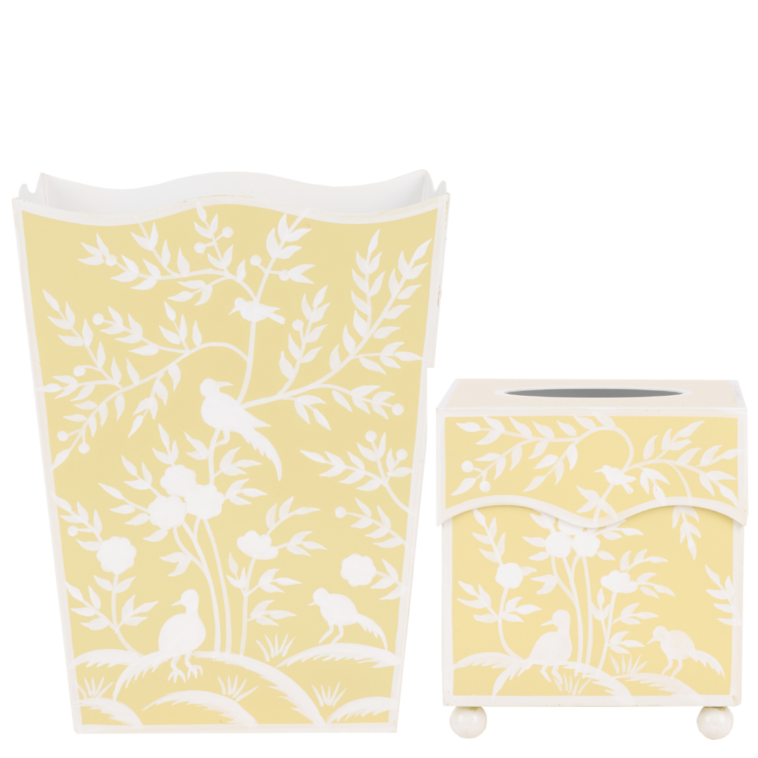 Yellow trash can with white bird and leaf pattern on a white background