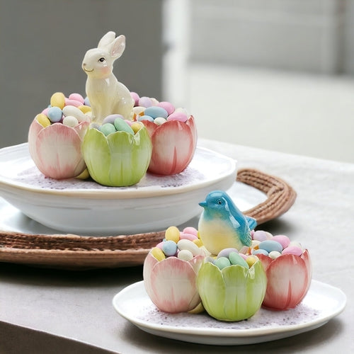 Decorative Easter scene with a rabbit, eggs, and a bird on a white plate.