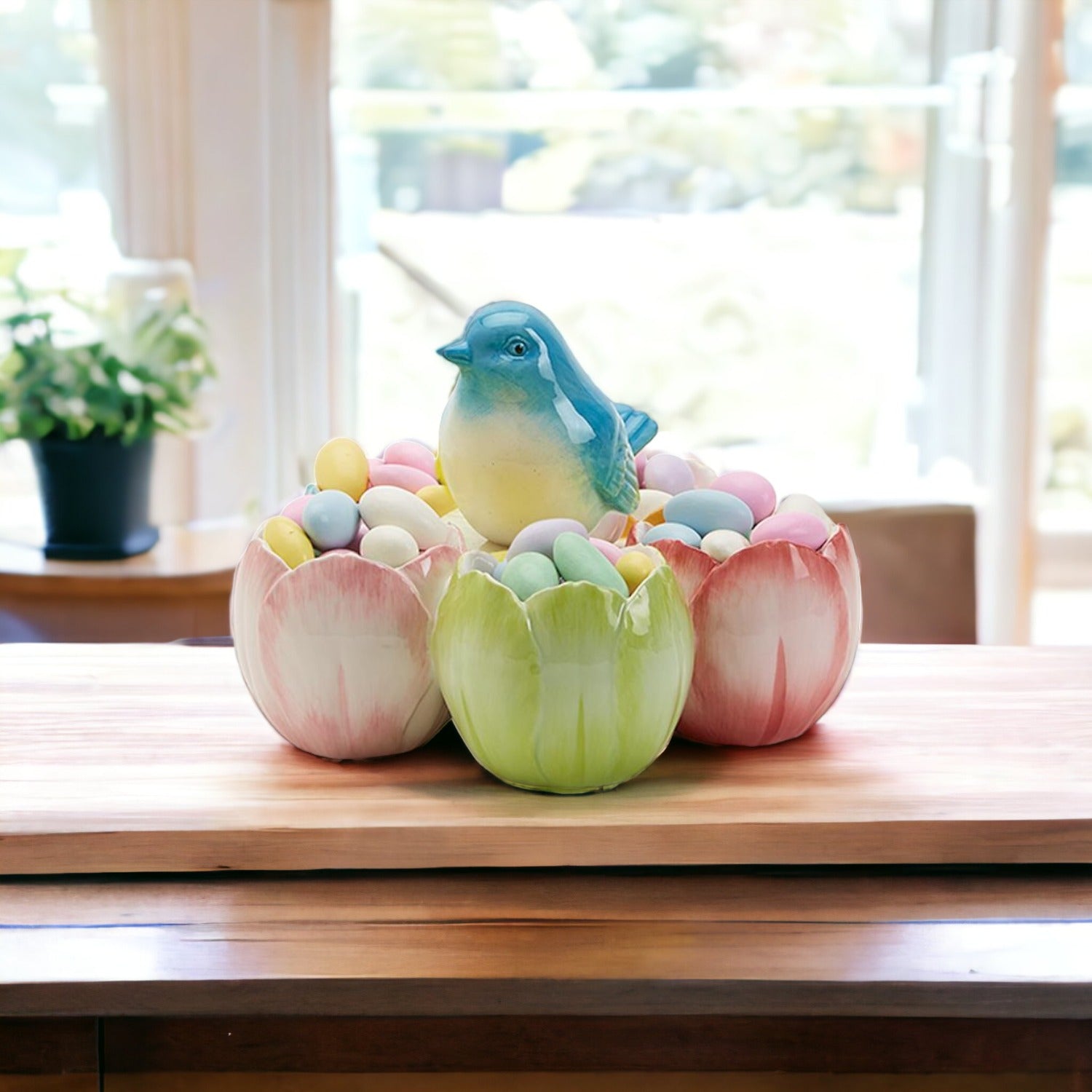 Decorative set of ceramic tulip-shaped bowls with colorful eggs and a bird figurine on a wooden surface.