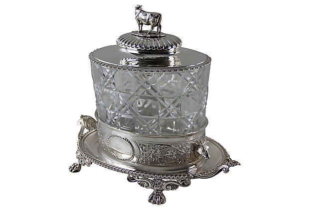 Angled view of an Antique sterling silver biscuit box London 1869 with crystal body, Victorian English silver container with cow finial