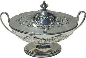 Decorative silver serving dish with lid on a white background