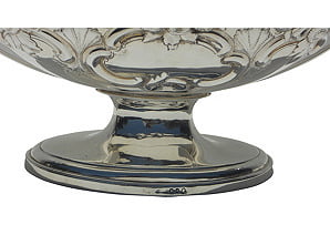 Silver decorative bowl with intricate designs on a white background
