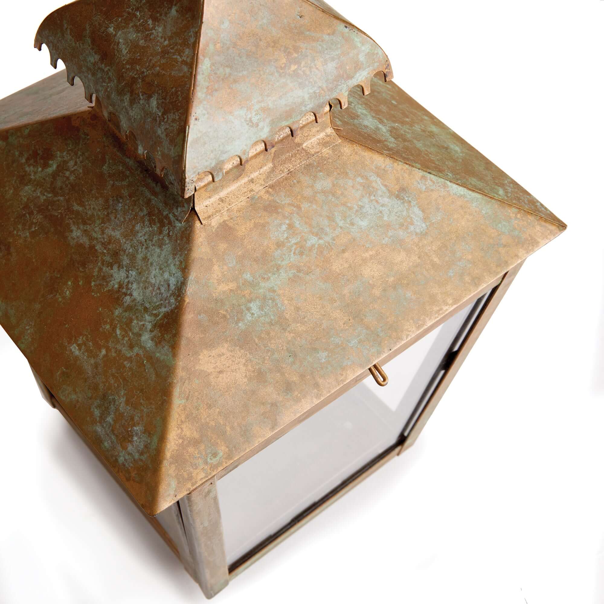 Copper lantern with a textured surface on a white background