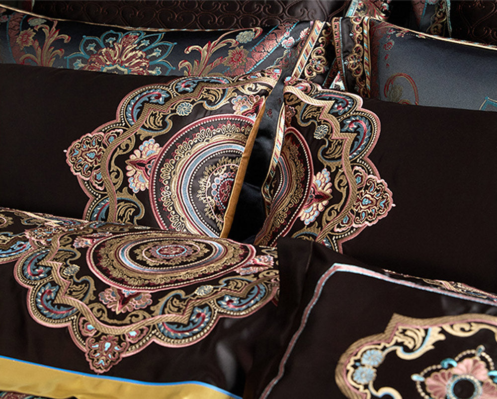 Decorative pillows with intricate paisley patterns on a dark background