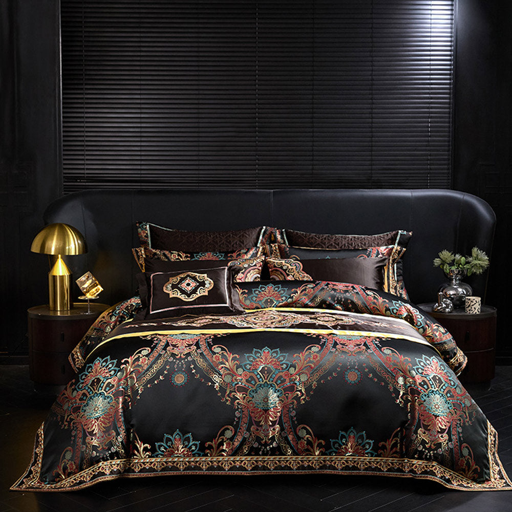 Decorative bedding set with intricate patterns on a bed in a darkly decorated room.