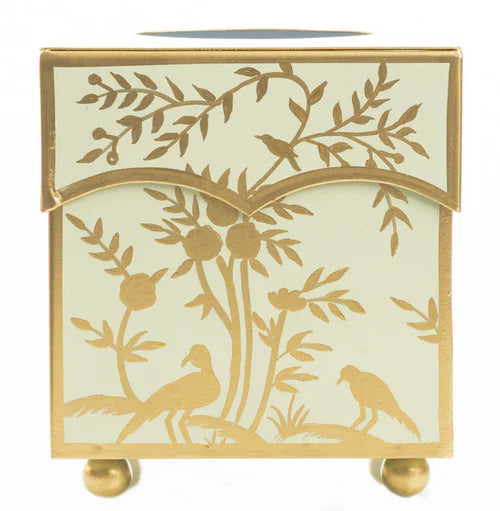 Decorative tissue holder with gold leaf design on a white background