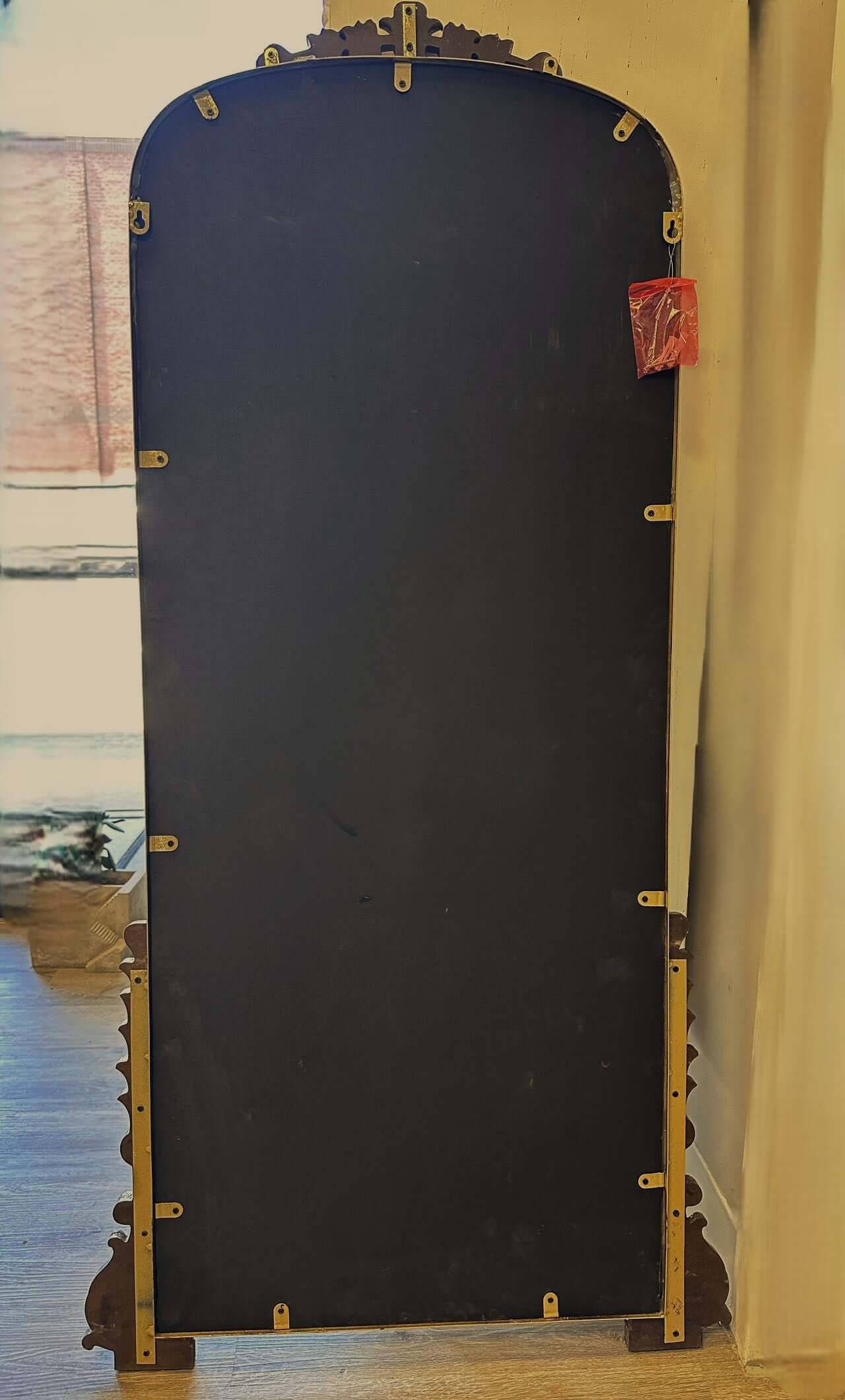 Large blue garment bag with gold accents on a wooden floor.