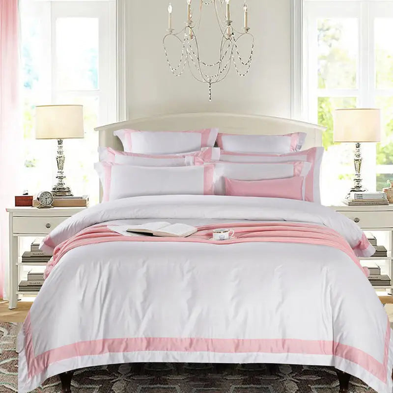 Bedroom with white and pink bedding set, nightstands, and a chandelier.