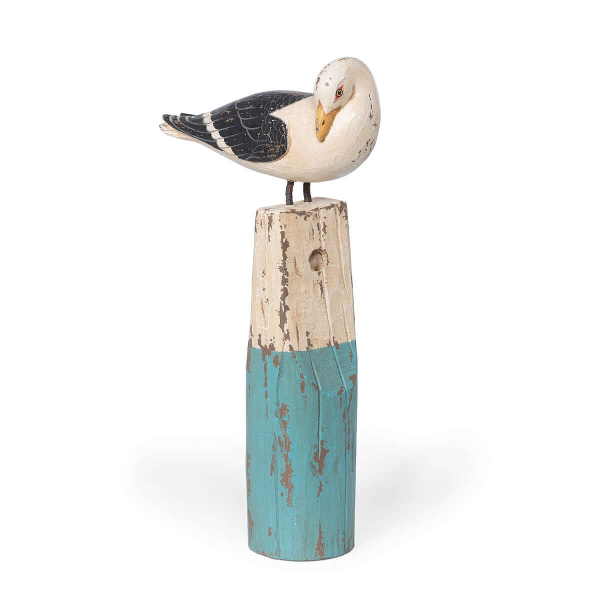 Decorative seagull figurine on a wooden post with a white background