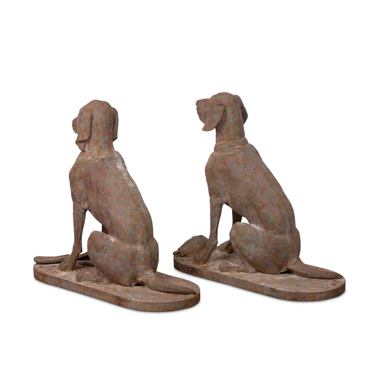 Two rusted metal dog statues on a white background