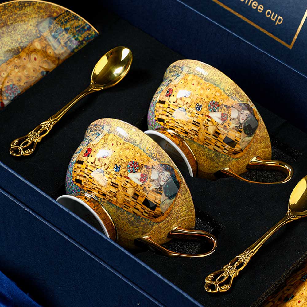 Decorative coffee cup set with 'The Kiss' design in a box