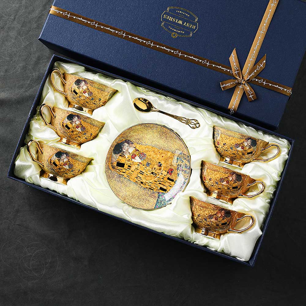 Set of decorative tea cups and saucers in a gift box with a ribbon.