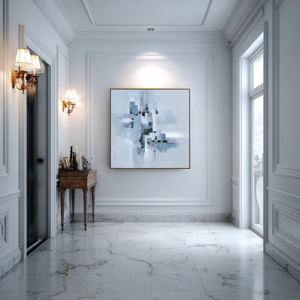 Elegant interior with marble flooring, white walls, and a framed abstract painting.