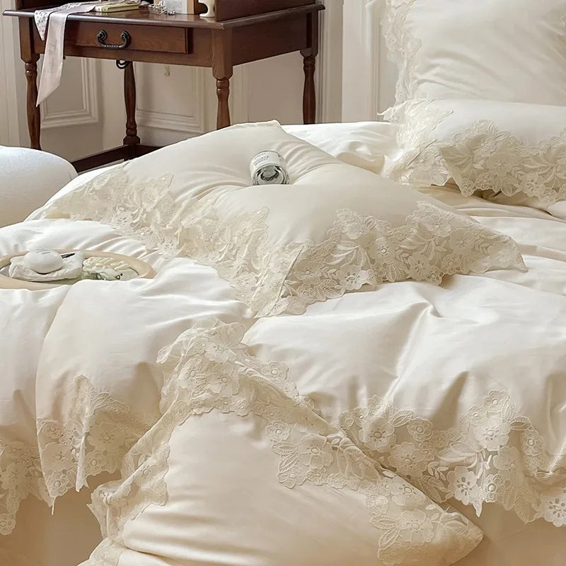 Close-up of lace-trimmed bedding with a wooden nightstand in the background.
