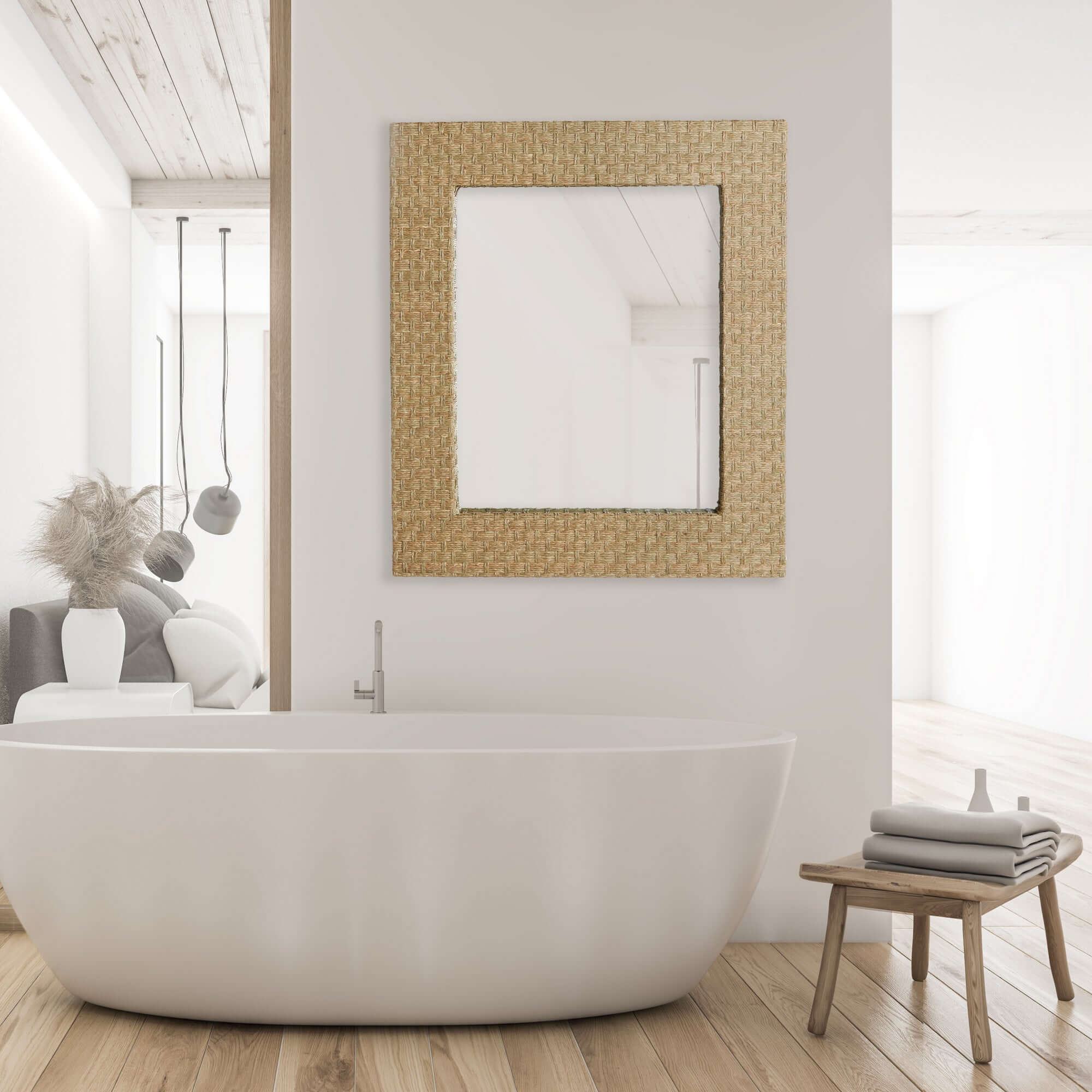 Modern bathroom with a freestanding bathtub, wooden stool, and decorative mirror.