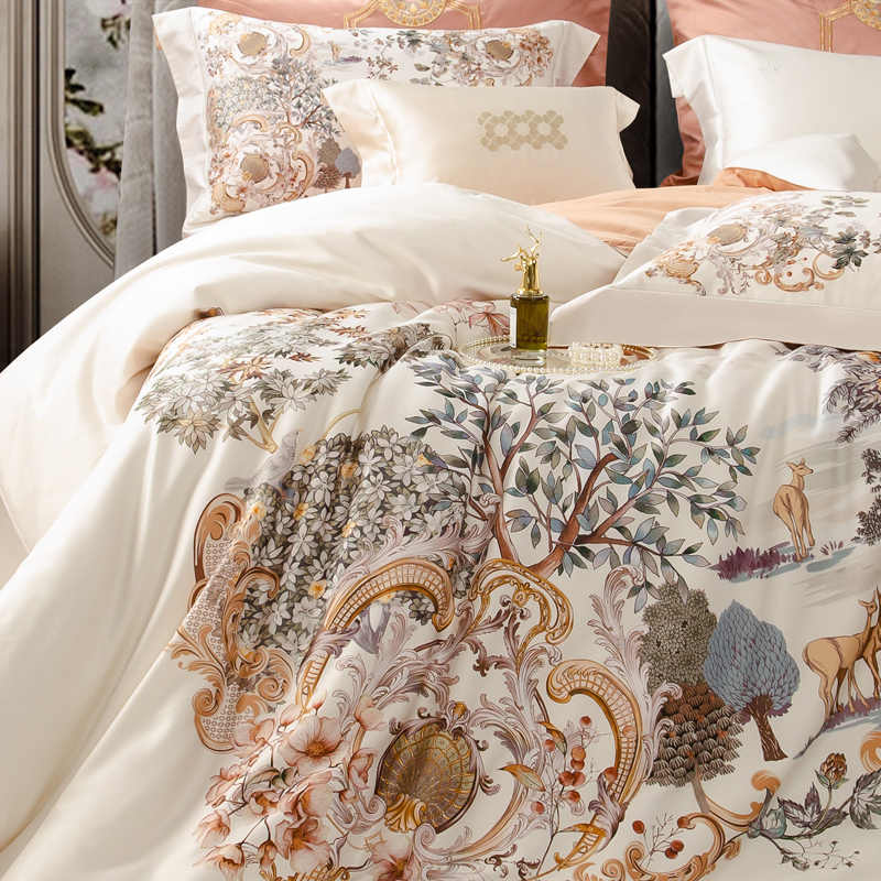 Decorative bedding set with nature-themed design on a bed.