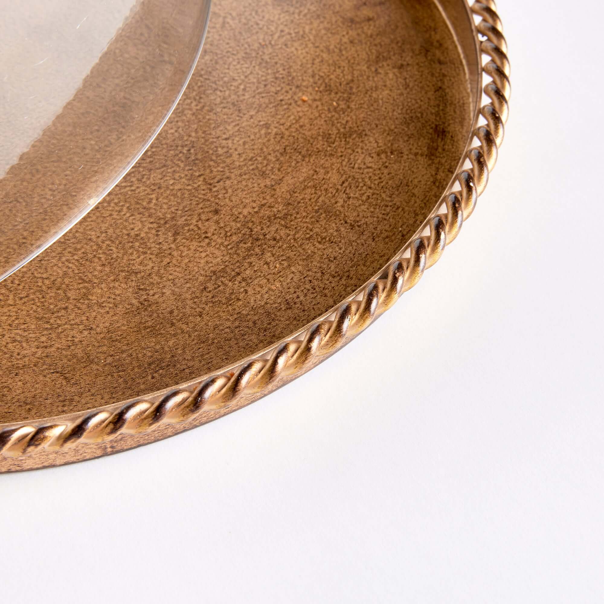 Round wooden tray with a decorative gold edge on a white background