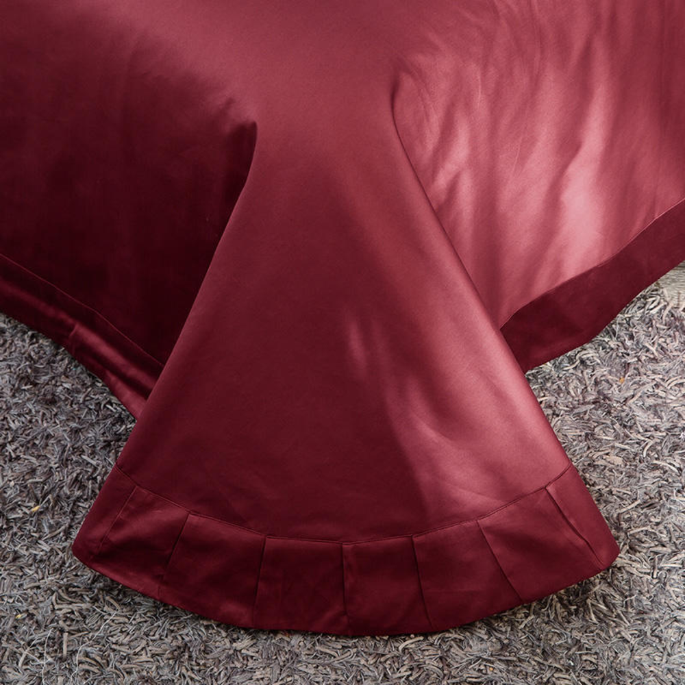 Close-up of a burgundy pillow on a textured surface