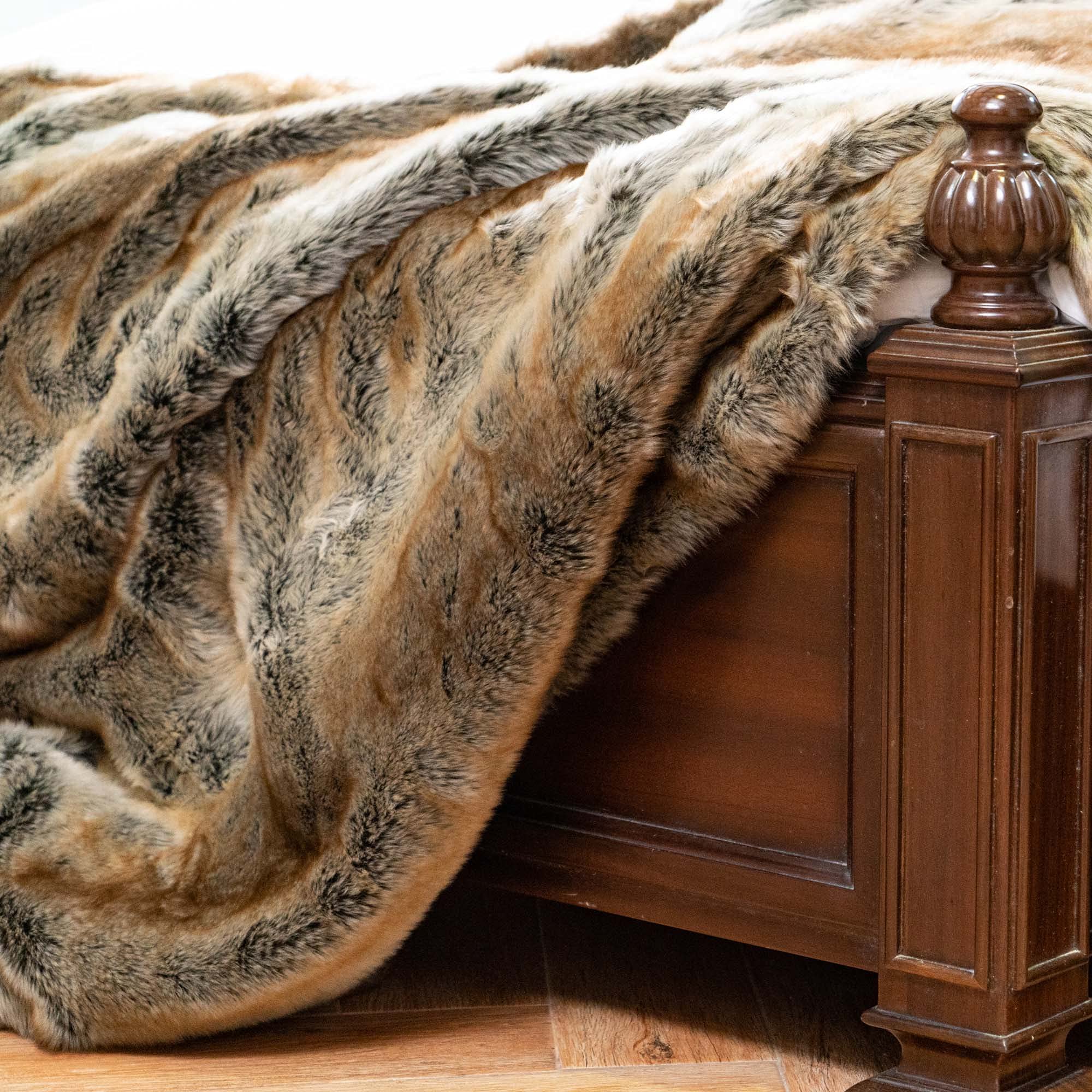 Fur throw blanket draped over a wooden bedpost