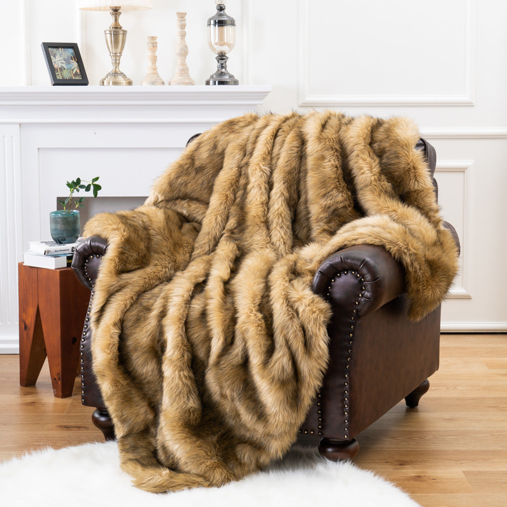 Brown fur throw blanket draped over a brown armchair in a living room setting.