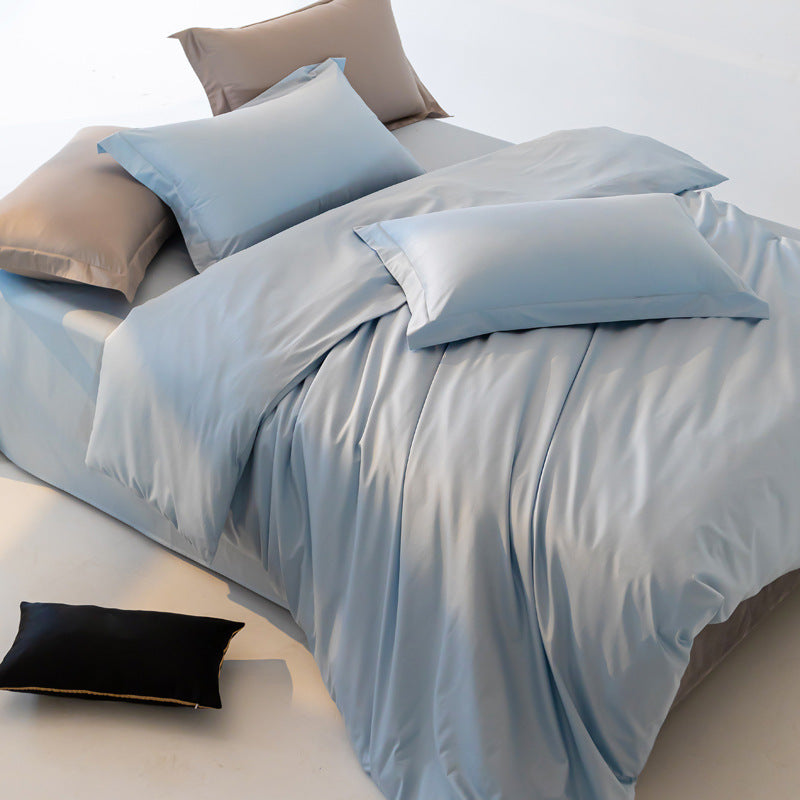 Light blue bedding set on a bed with pillows