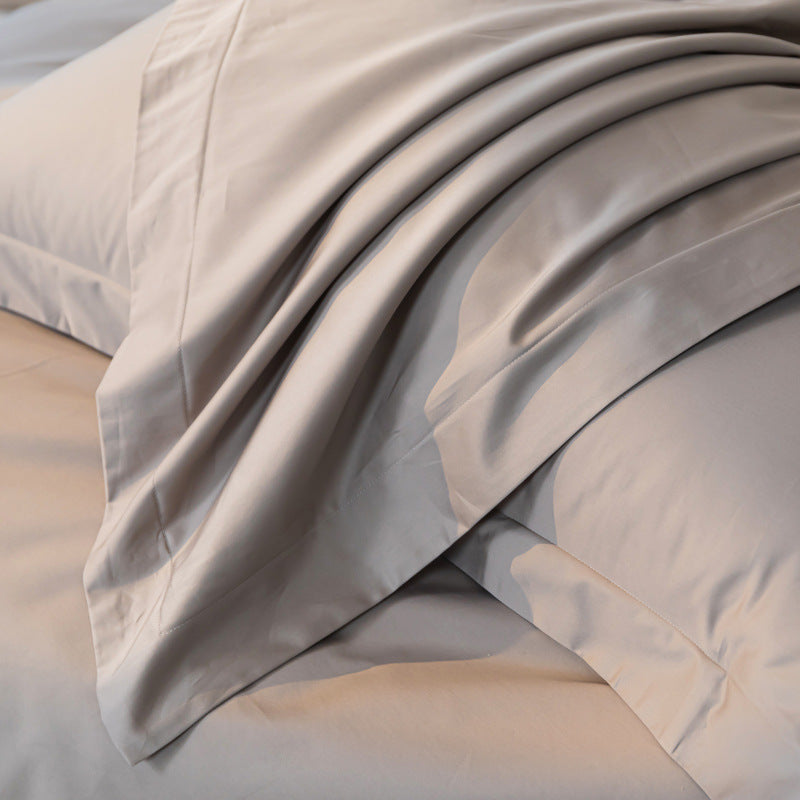 Close-up of beige bedding with a soft texture on a neutral background