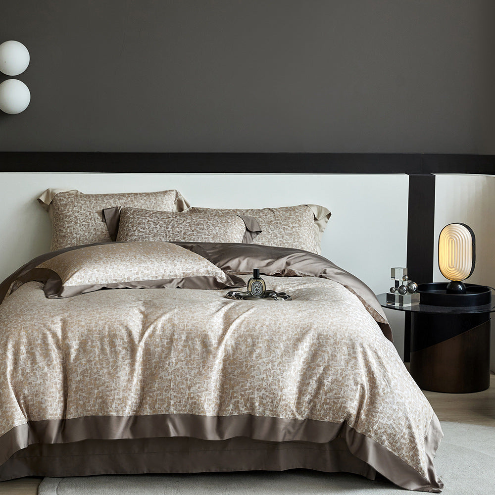 Neatly made bed with patterned bedding in a modern bedroom setting.