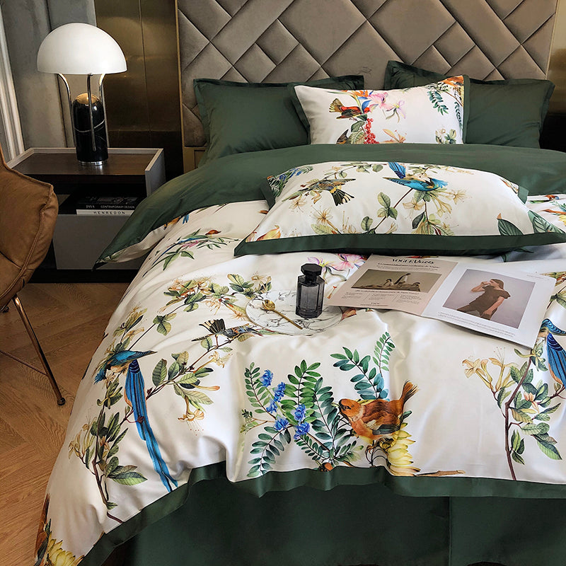 Floral and bird patterned bedding set on a bed in a bedroom setting.