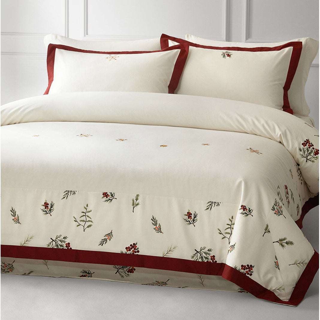 Embroidered bedding set with floral patterns on a white background