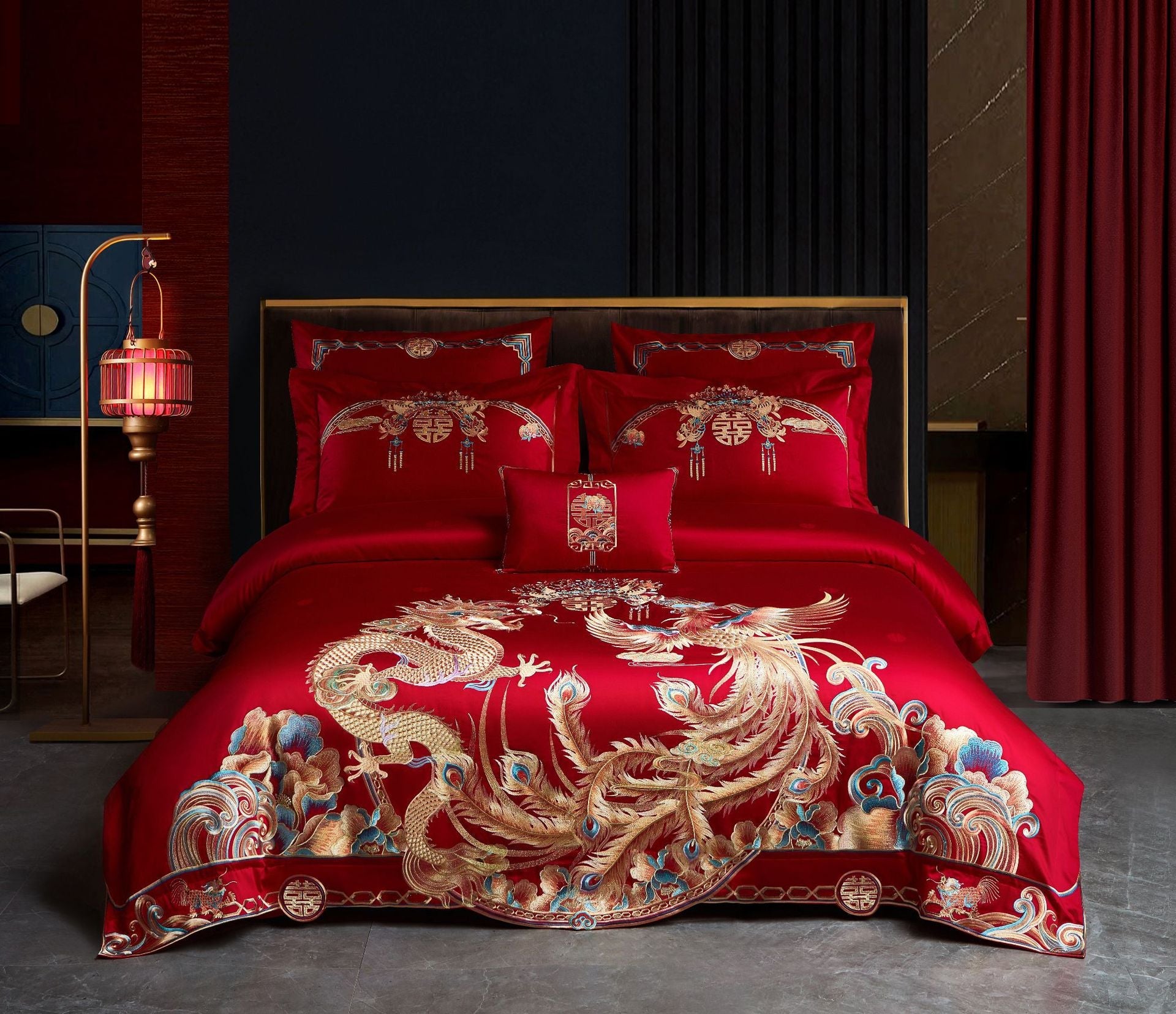 Red embroidered bedding set with gold dragons on a bed in a room.