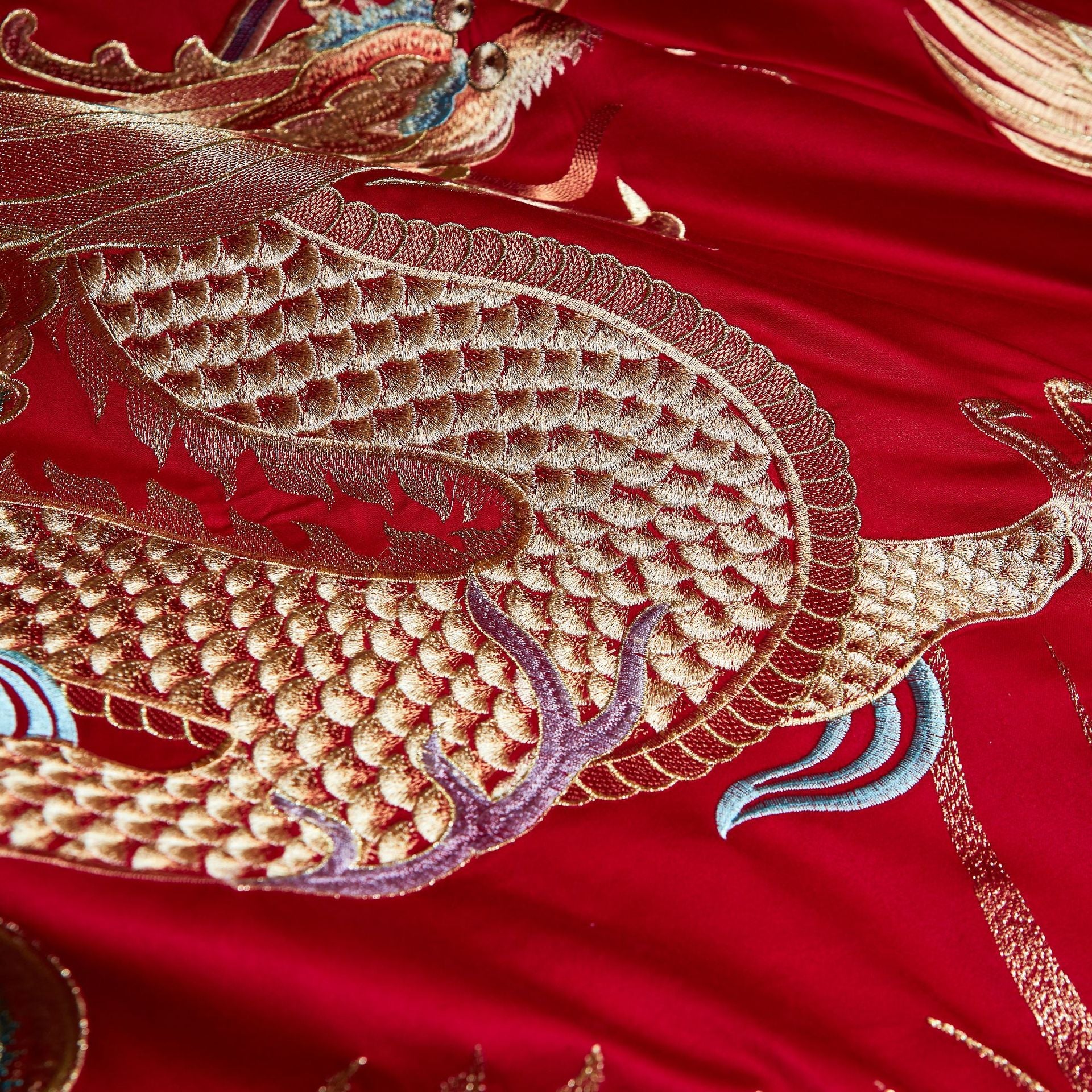 Embroidered dragon design on red fabric