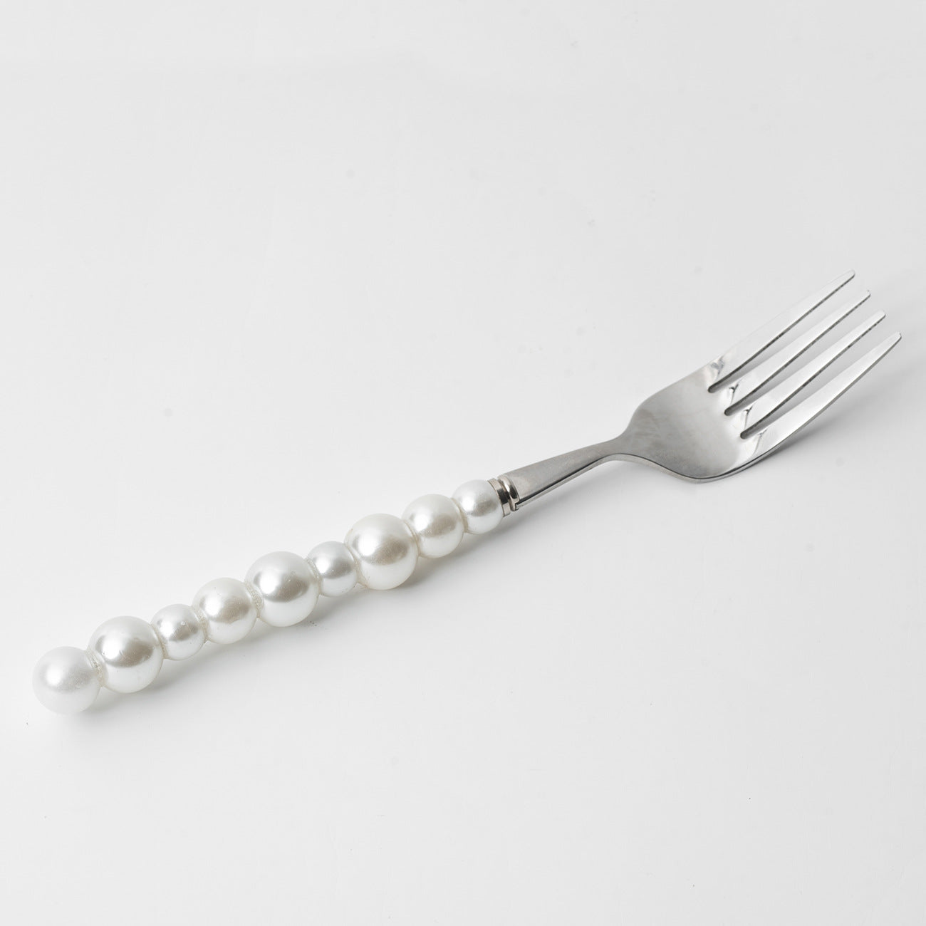 Fork with pearl handle on a white background