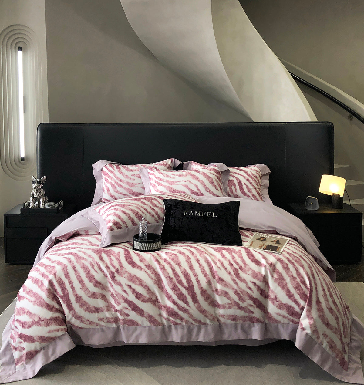 Bed with pink and white zebra pattern bedding in a modern bedroom setting.