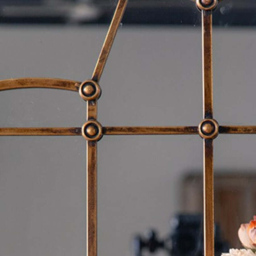 Close-up of a decorative metal grid with a blurred background