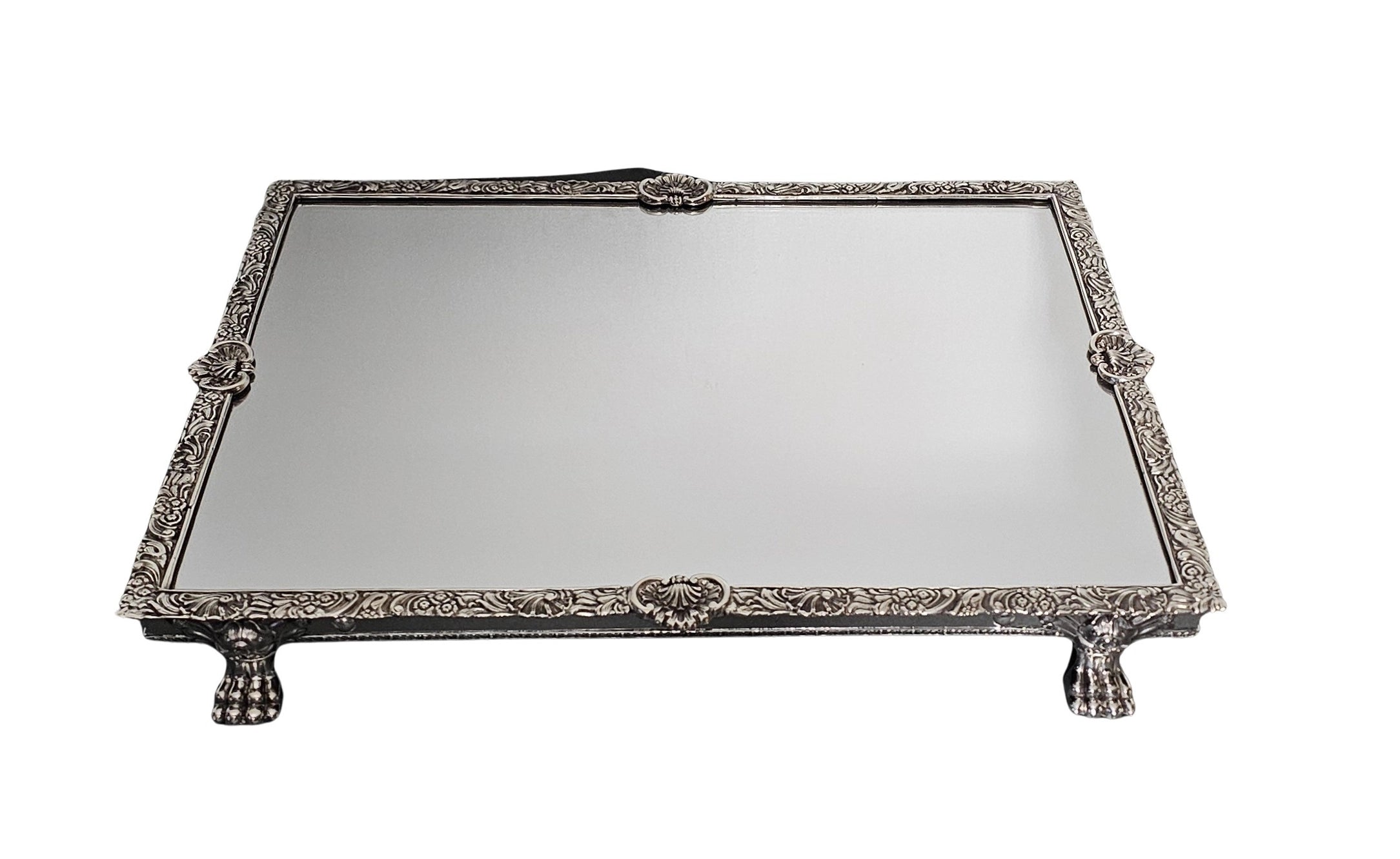 Decorative silver tray with intricate designs on a white background