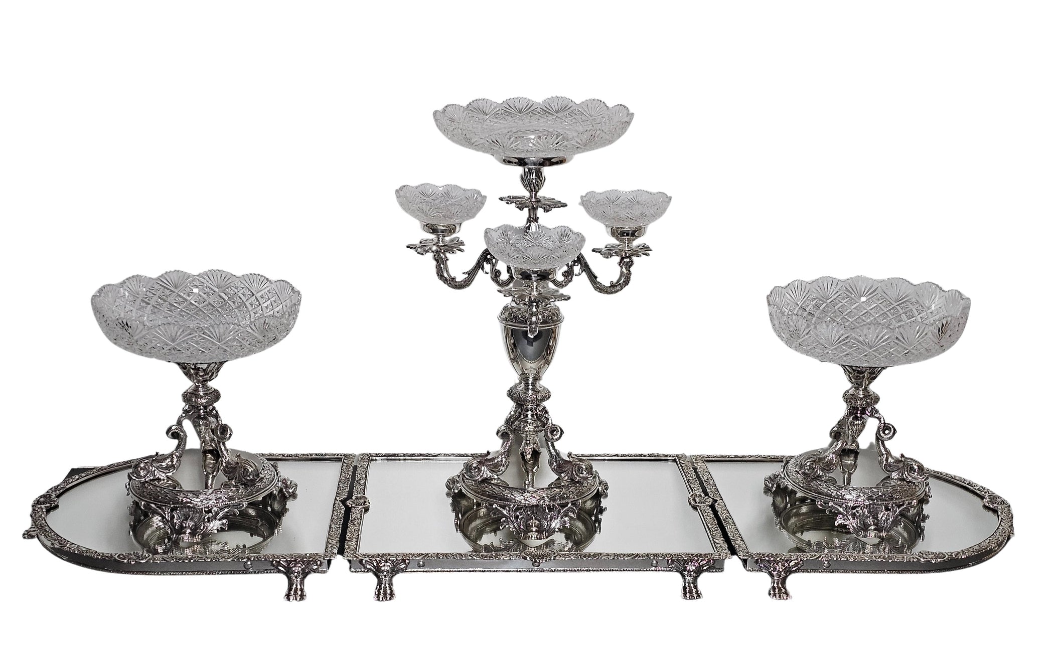 Decorative silver candelabrum with crystal bowls on a white background