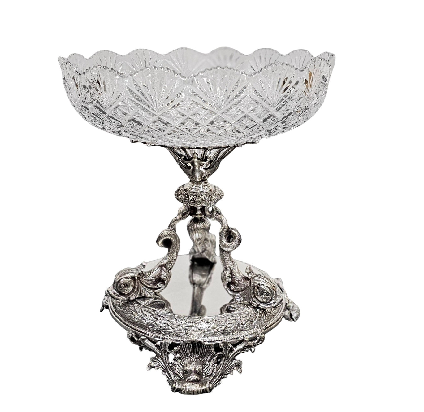 Decorative crystal bowl with silver stand on a white background