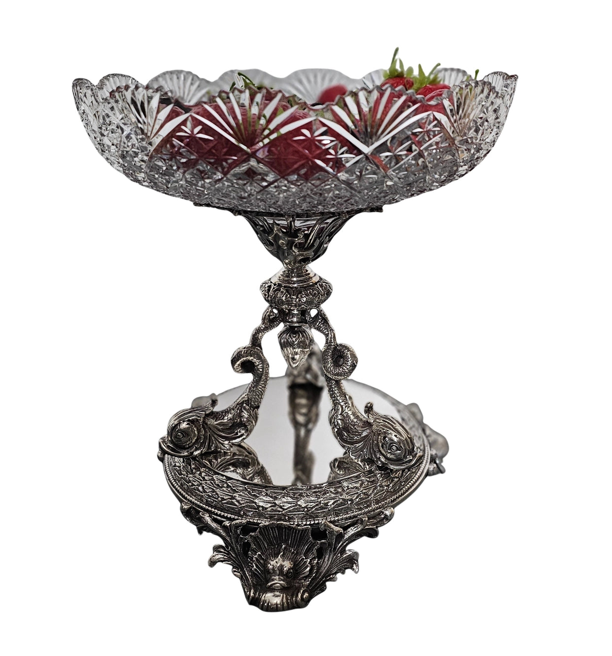 Decorative silver bowl with intricate design on a white background