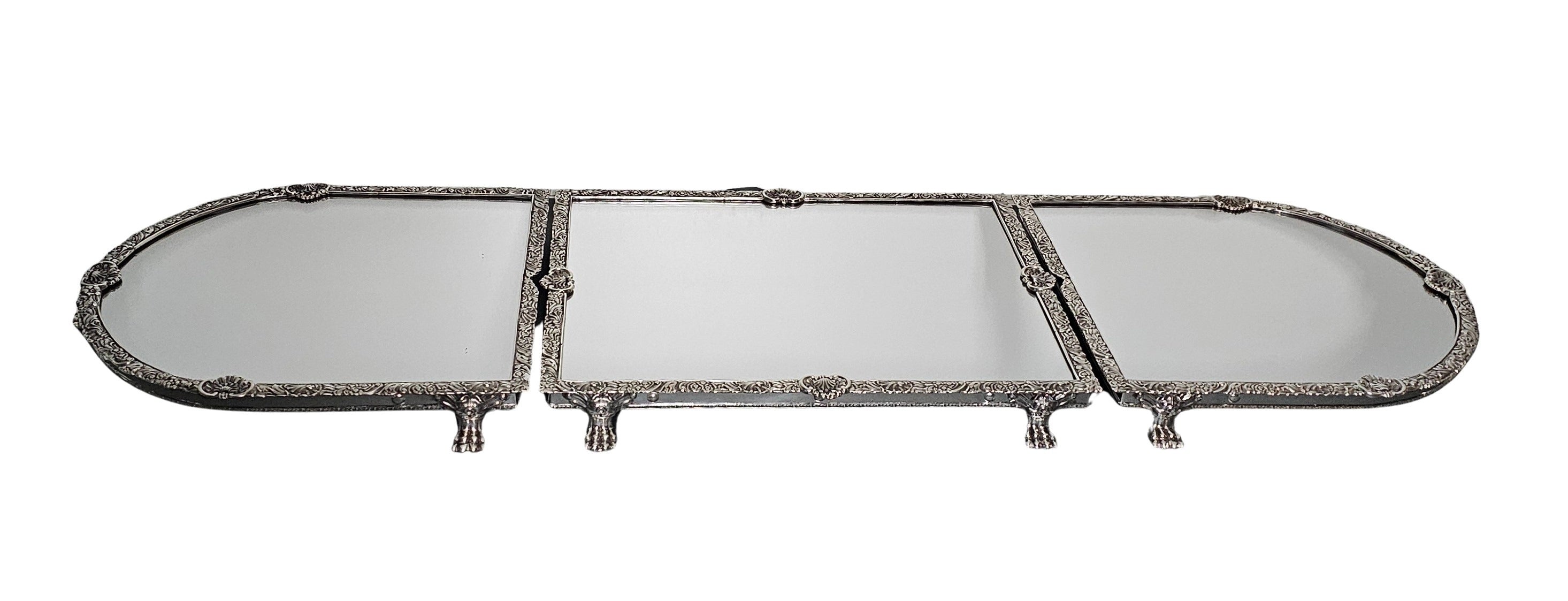 Long, narrow mirror with three sections on a white background